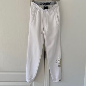 Nike women’s XS white sweat pants with silver and gold graphics. Gently worn.